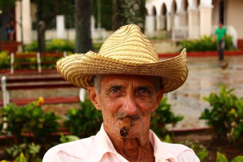 Old man with straw hat smoking habano in Cuba