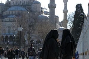 Two muslim ladies with burka talking in the street