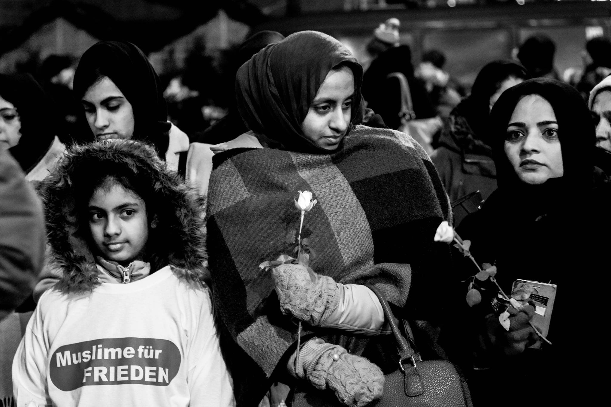 Muslim ladies on a protest with flowers in their hands