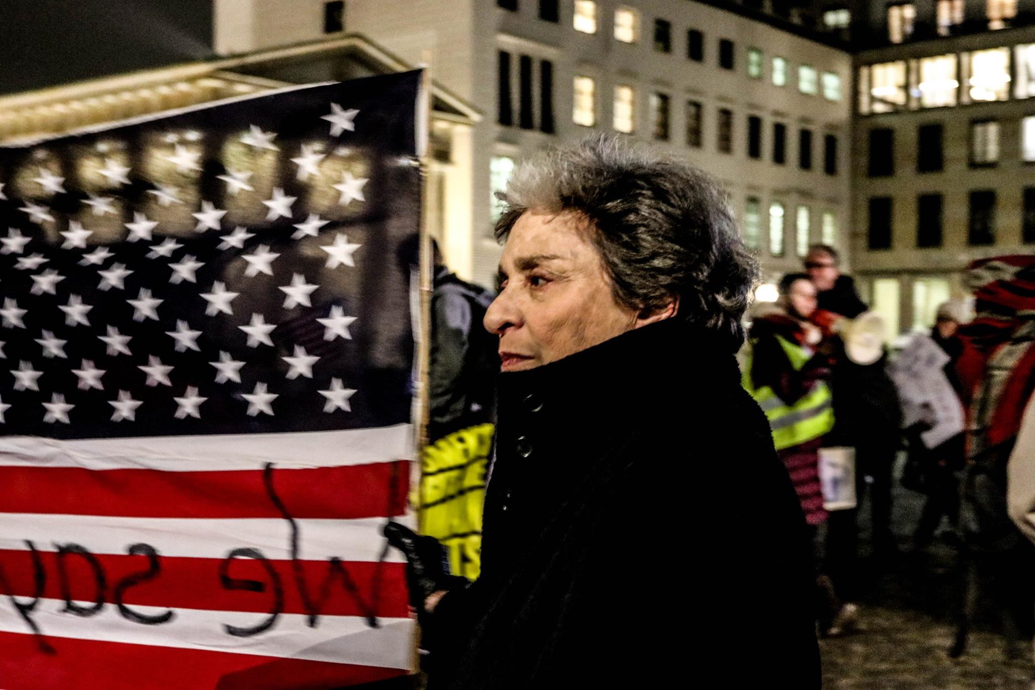 Old lady on a strike in Berlin with a United States' flag