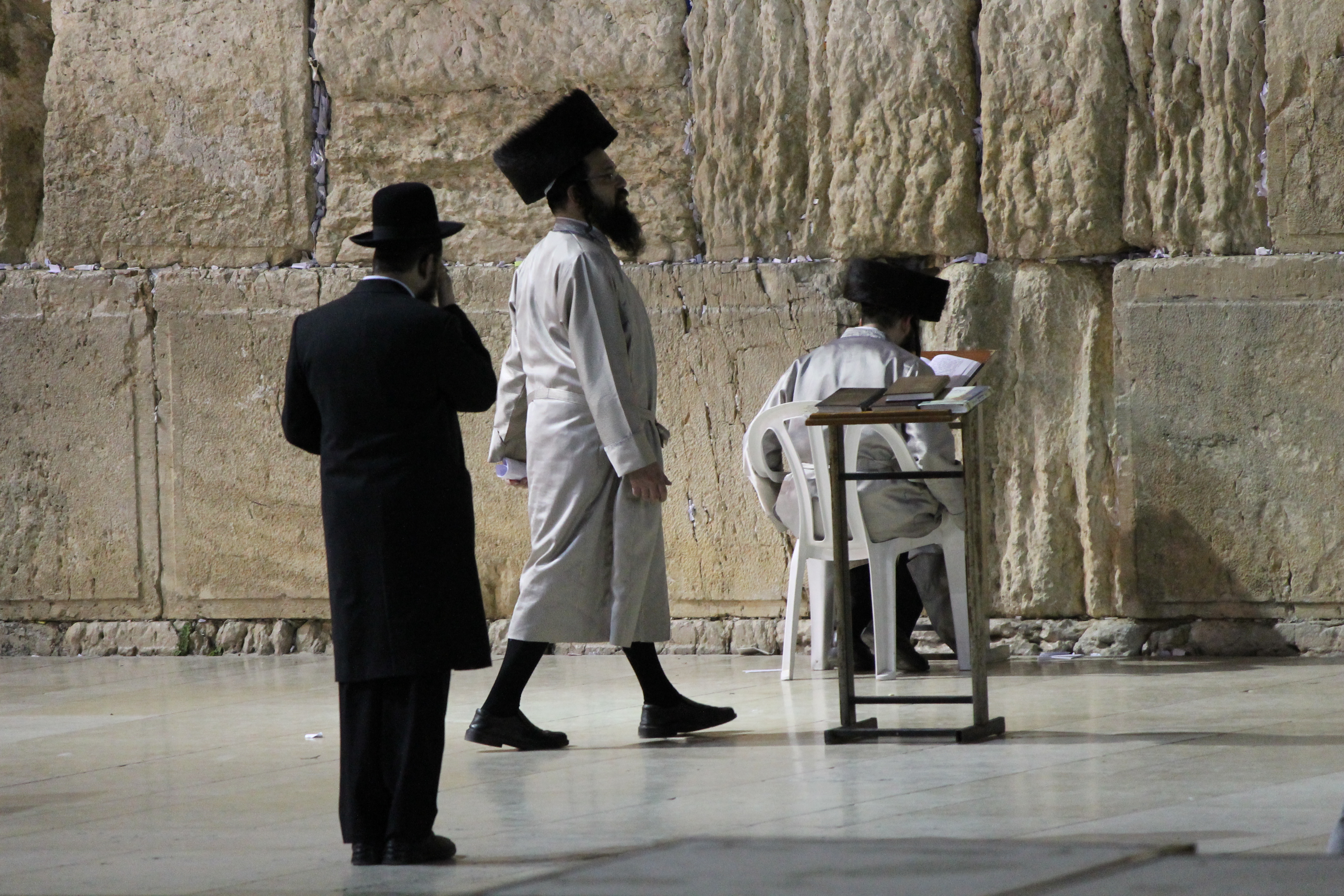 Three jews men in front of the Westen wall