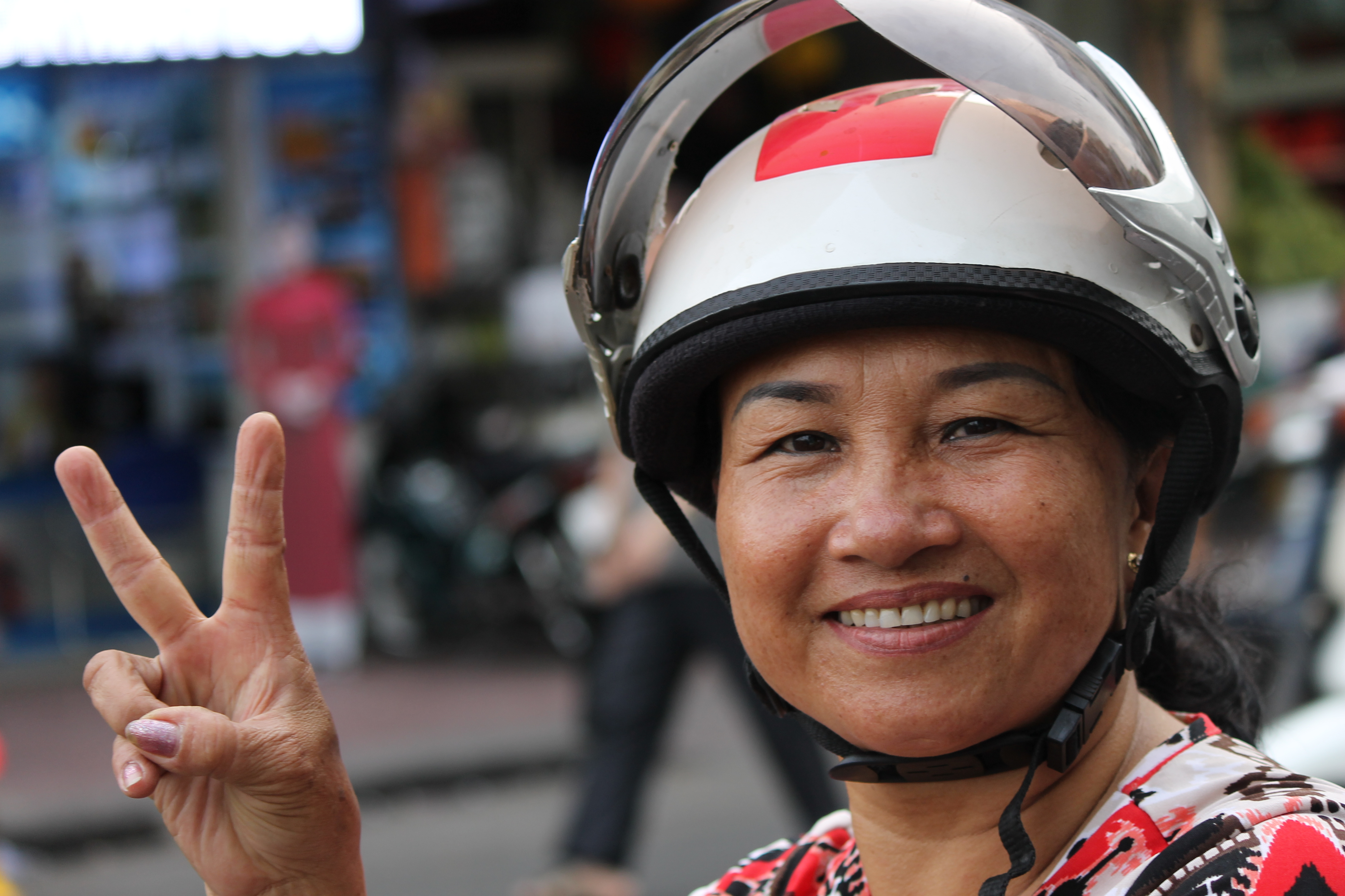 asian woman on motorcycle with helmet