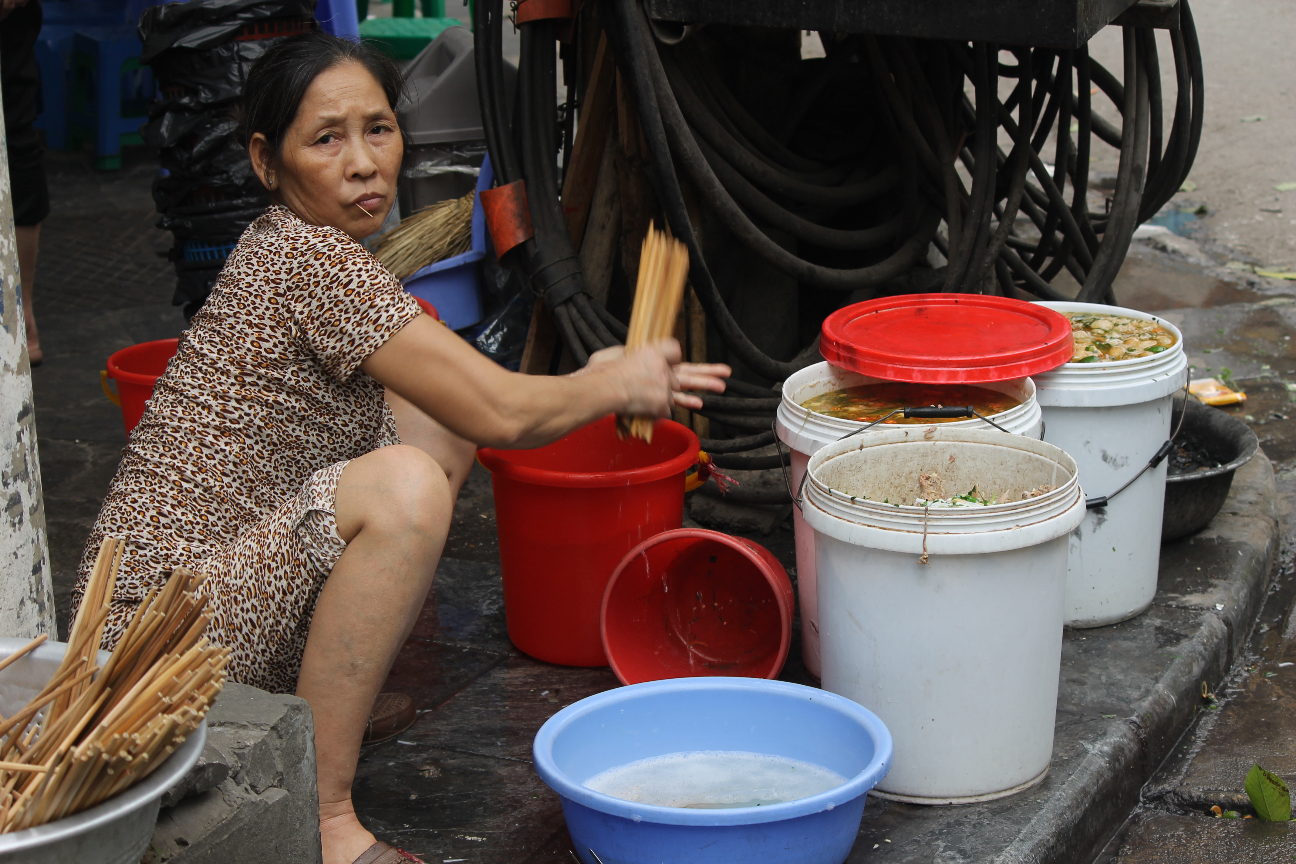 asian woman selling soup on the street